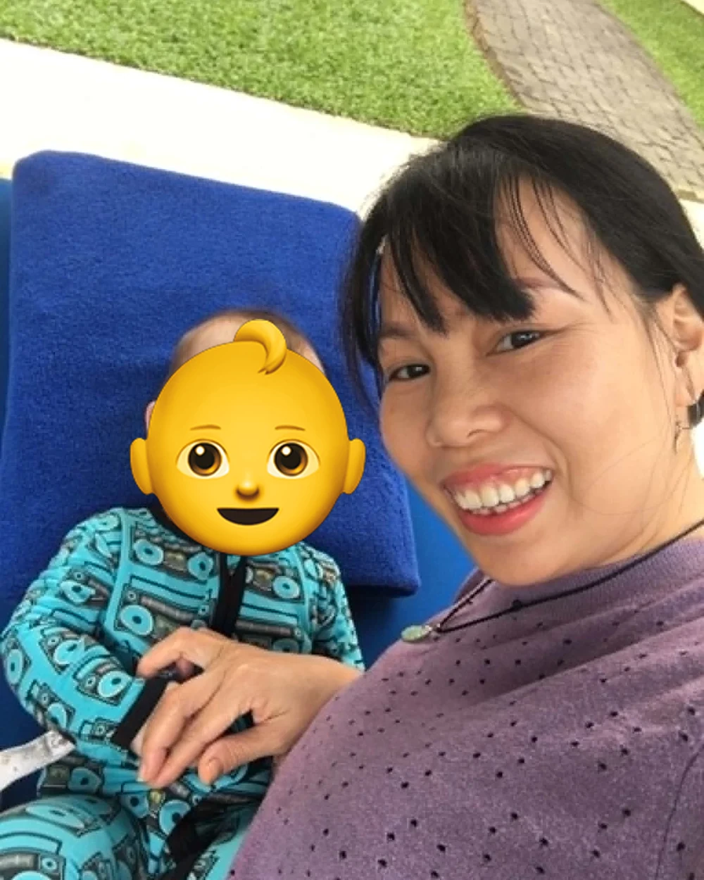 Trang outdoors with a child she cares for in Hoi An